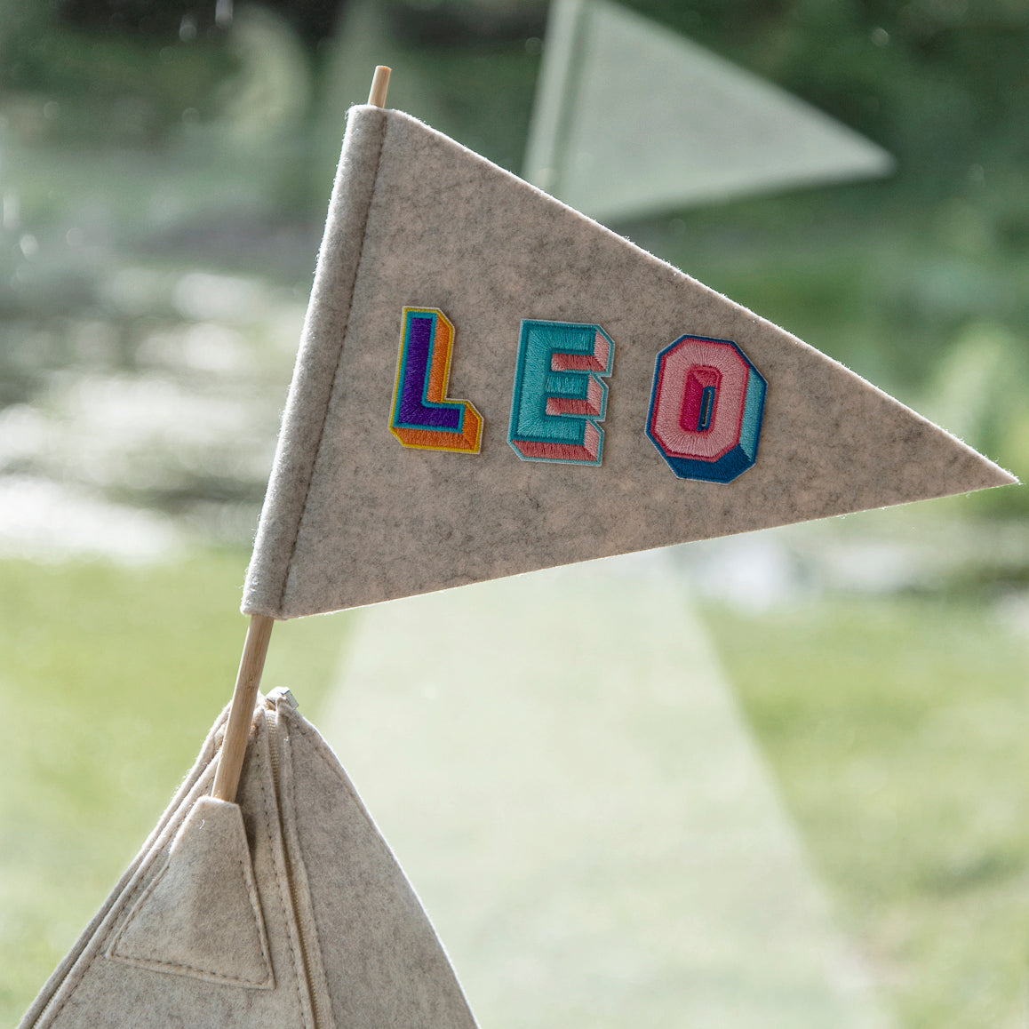 Custom teepee flag with 'LEO' letter patches for personalization