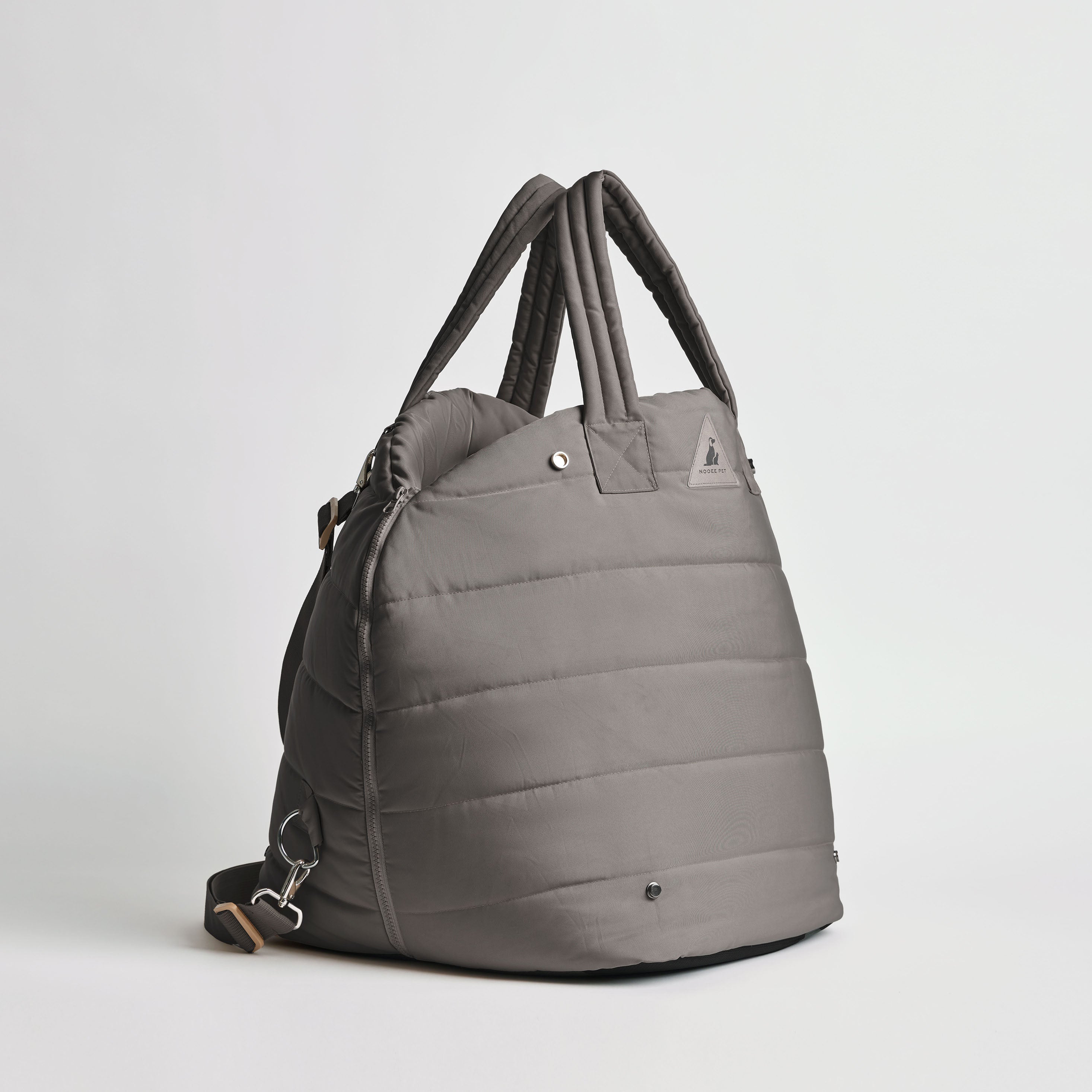 Side view of the Nooee Pet Lola Car Seat in modern gray nylon, featuring quilted padding, dual top handles, and an adjustable shoulder strap with silver hardware.