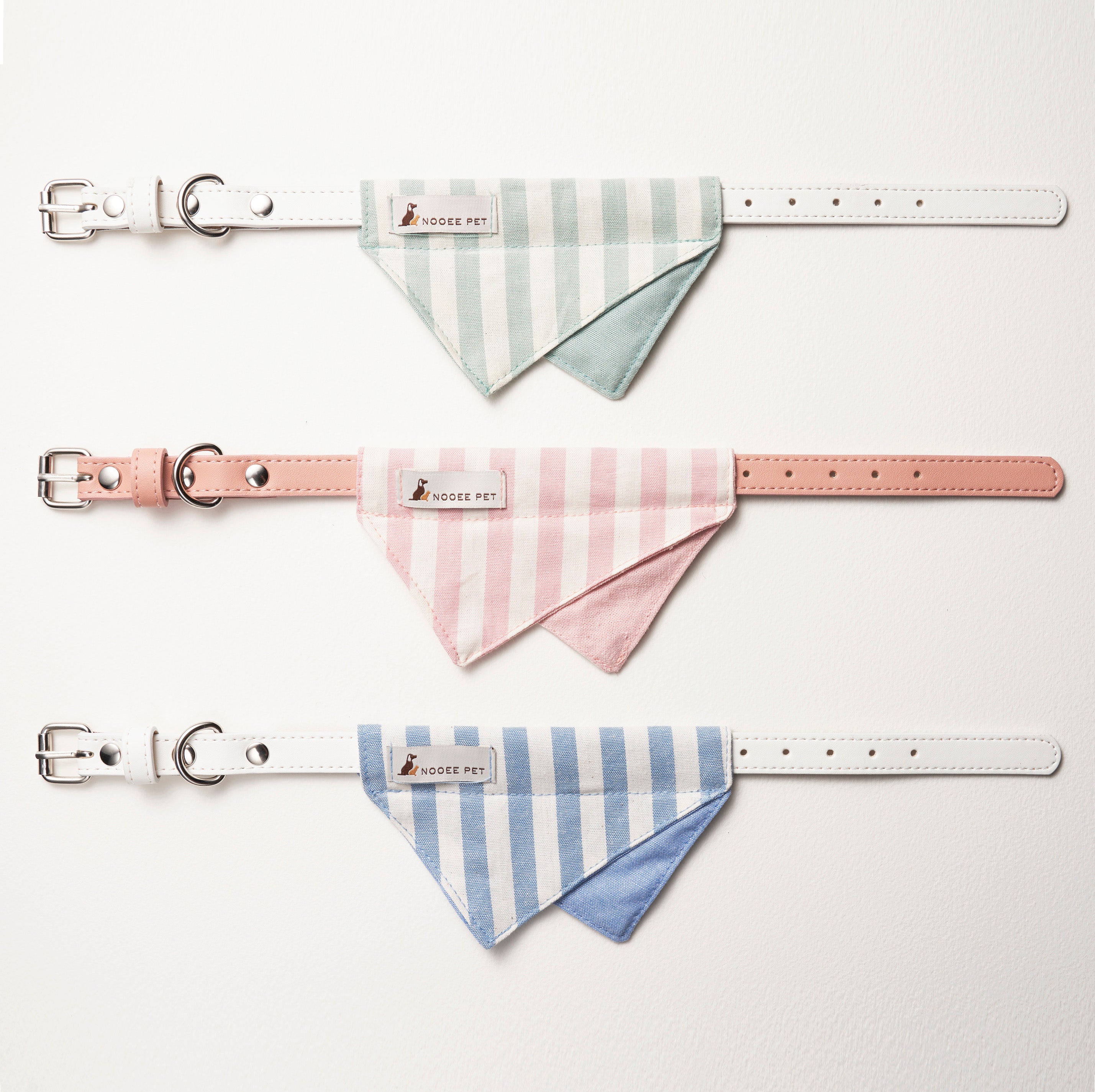Three Nooee Pet Daisy Collars in Green, Pink, and Blue with Bandanas laid flat