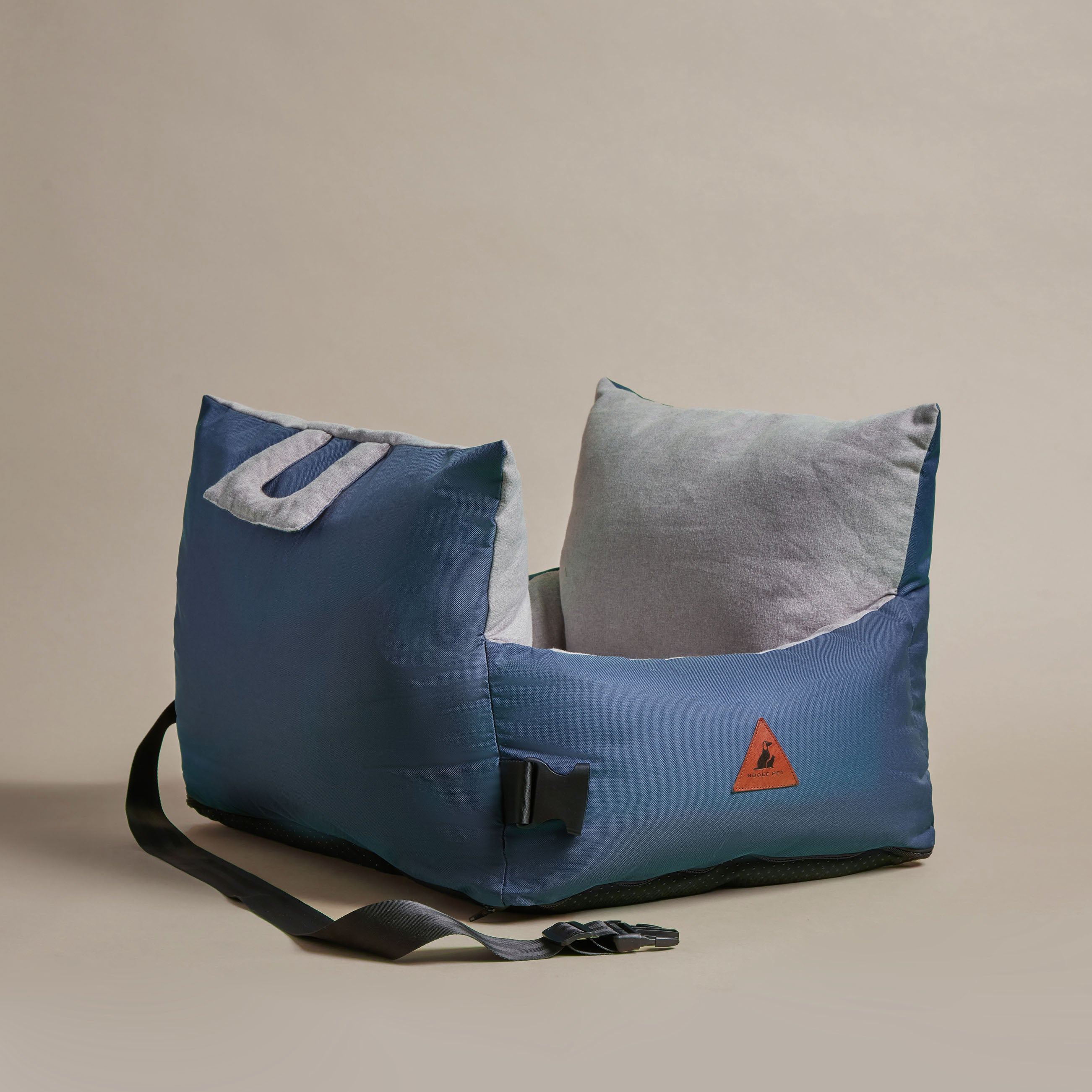 Nooee Pet Charlie Car Seat in navy nylon with soft gray cushions, safety strap, and side buckle on neutral background.