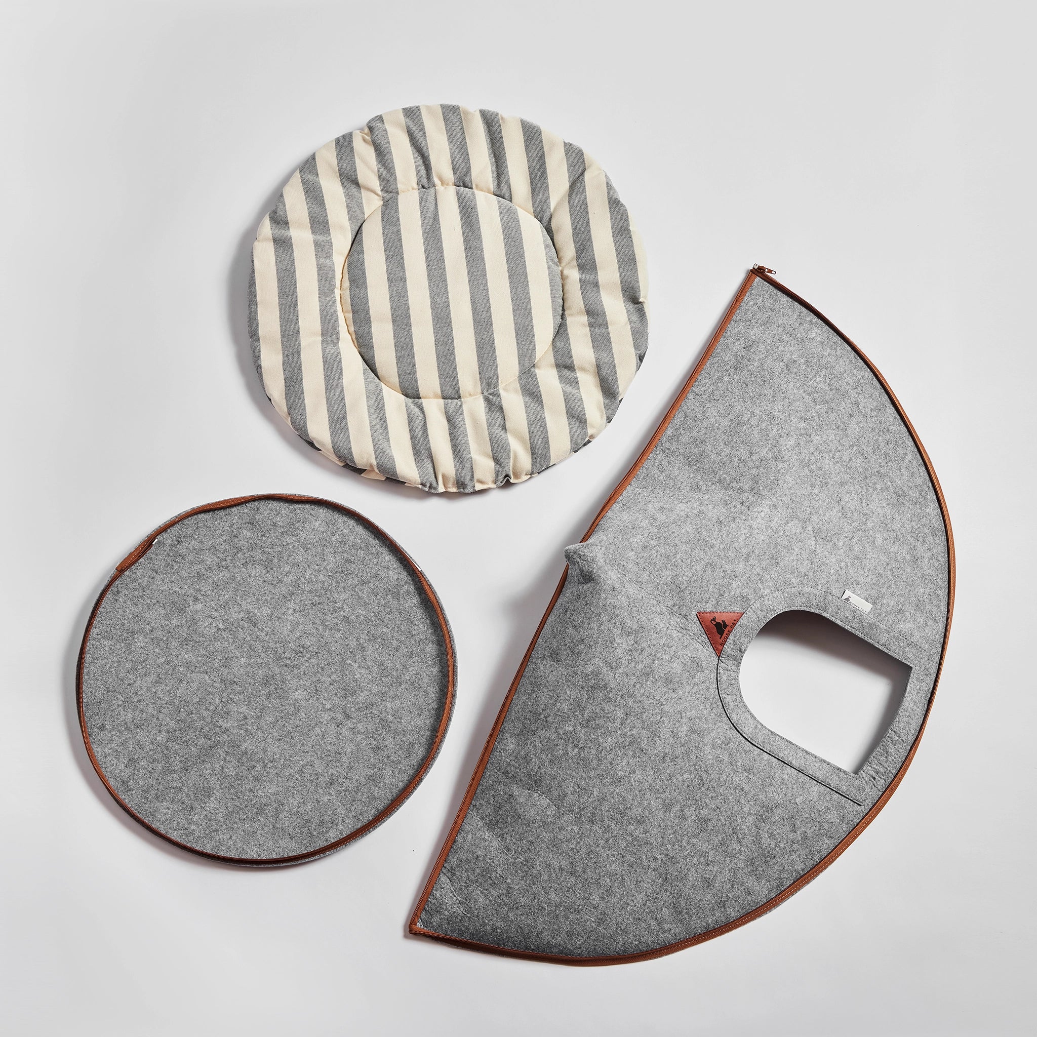 Disassembled Nooee Pet Cave Buddy (L) with its felt panels and striped cushion.