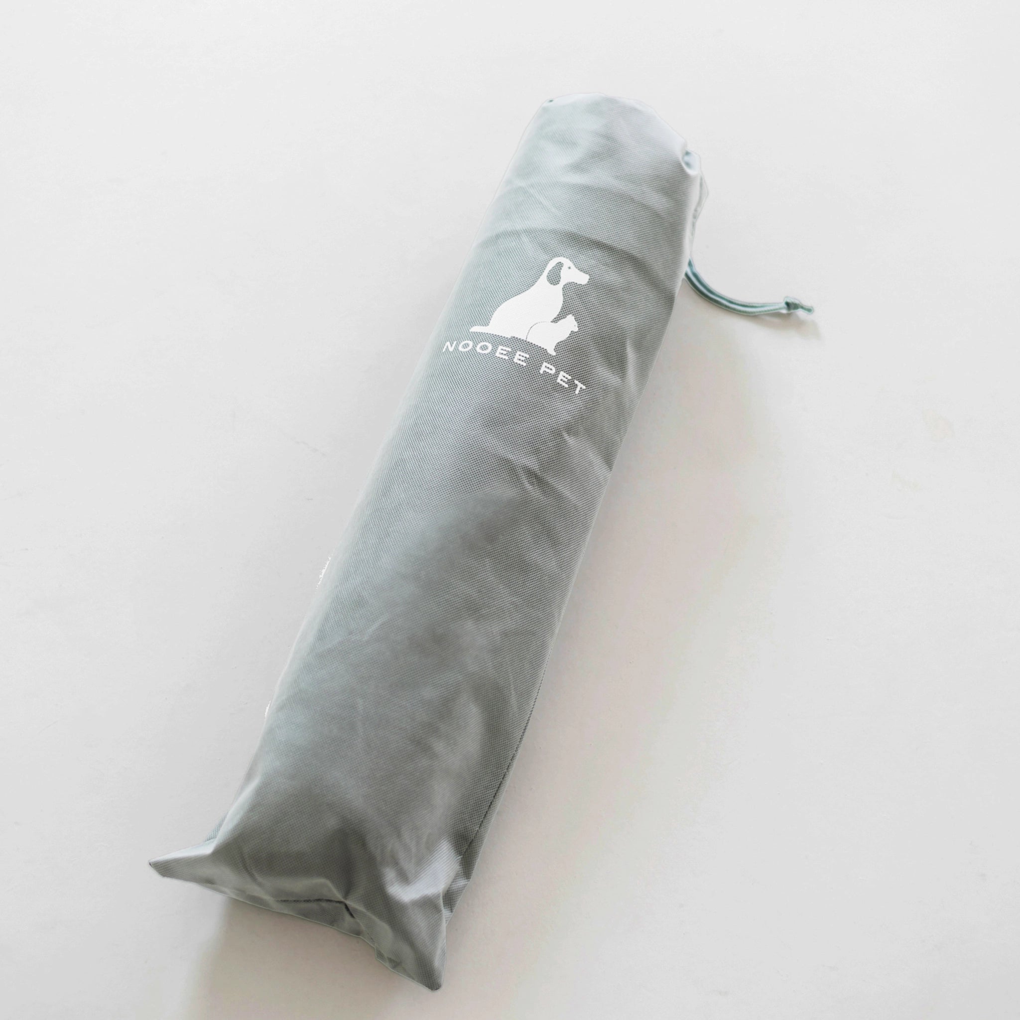 Nooee Pet Cave Buddy (L) stored in its compact, lightweight travel bag with Nooee Pet branding.