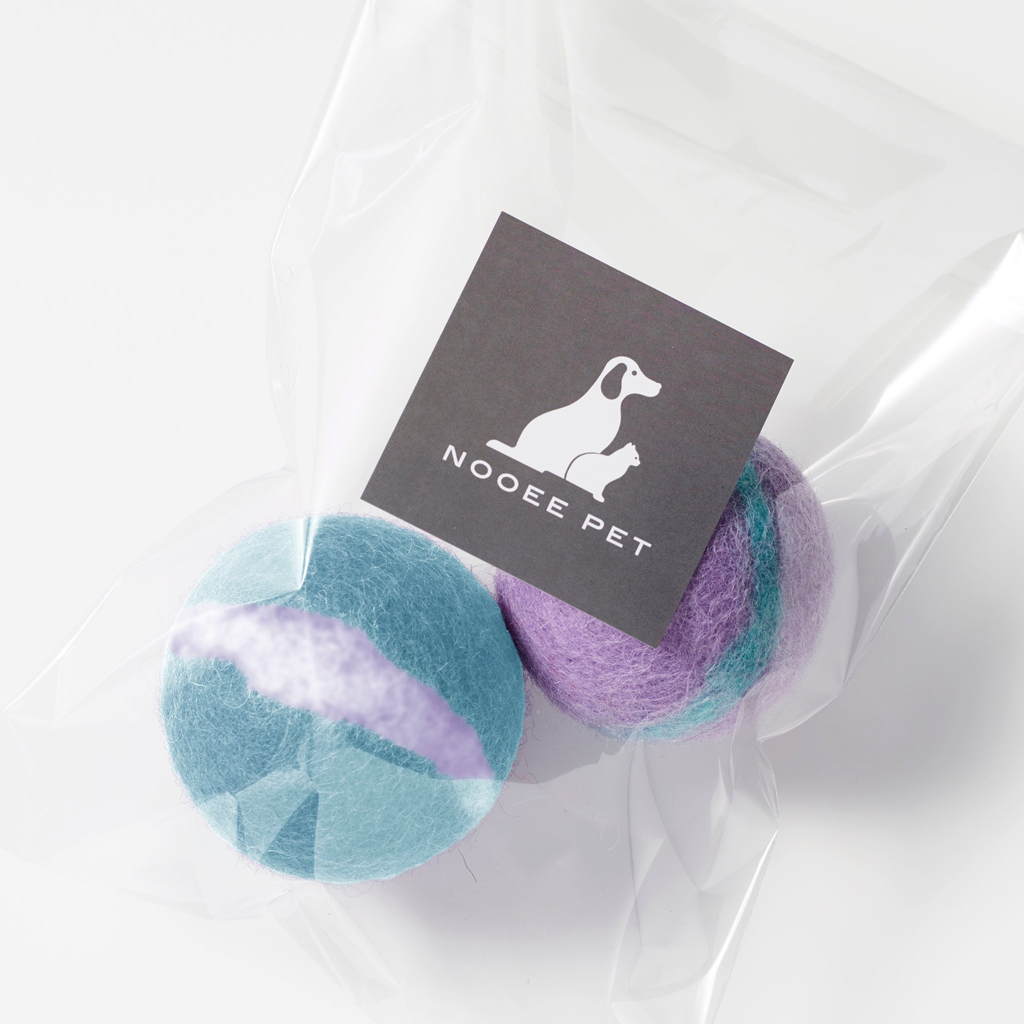 One mint and one purple wool toy balls with Nooee Pet label
