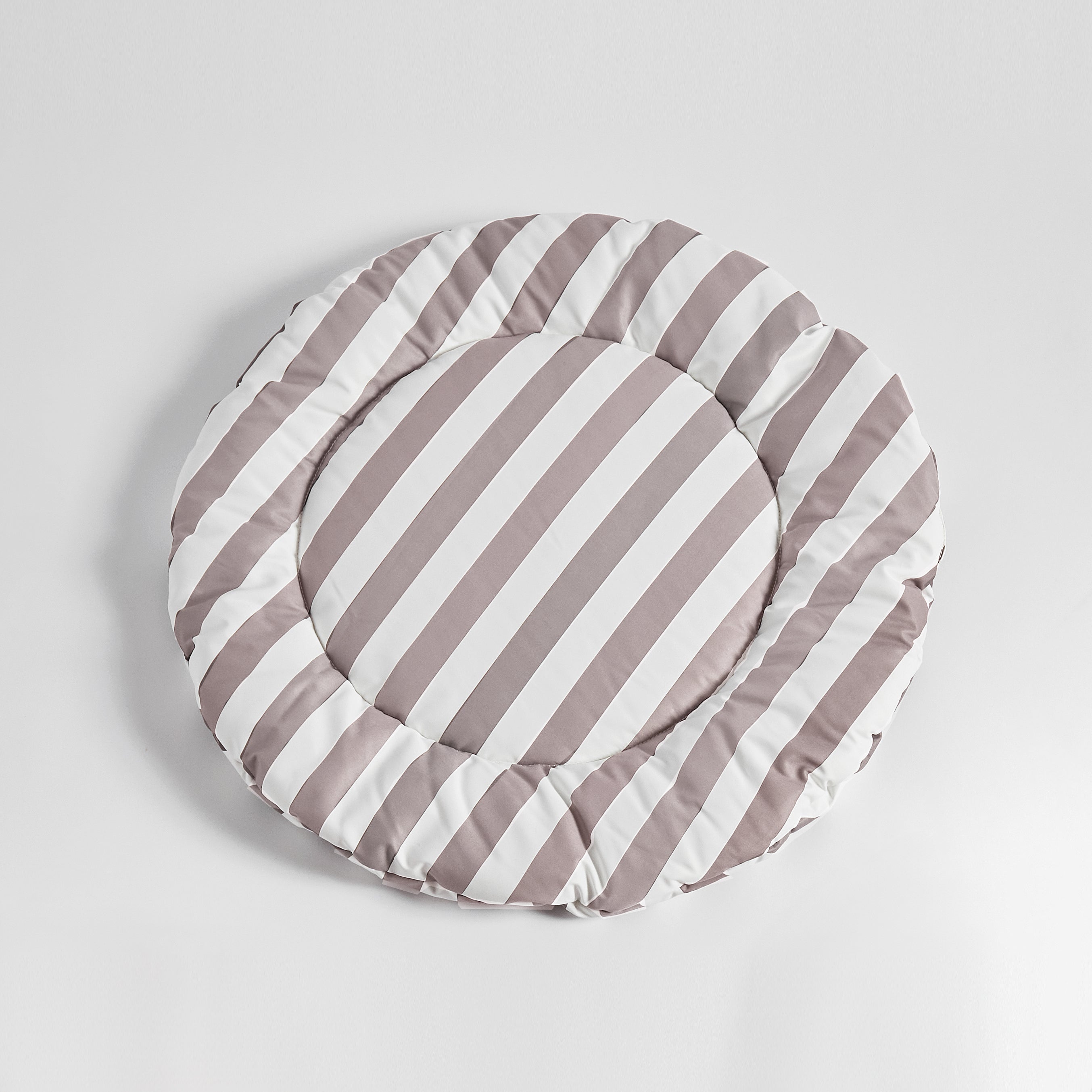 Flat-lay of Nooee Pet Replacement Cushion in beige and white stripes, showcasing its round shape and plush design against a clean white background.