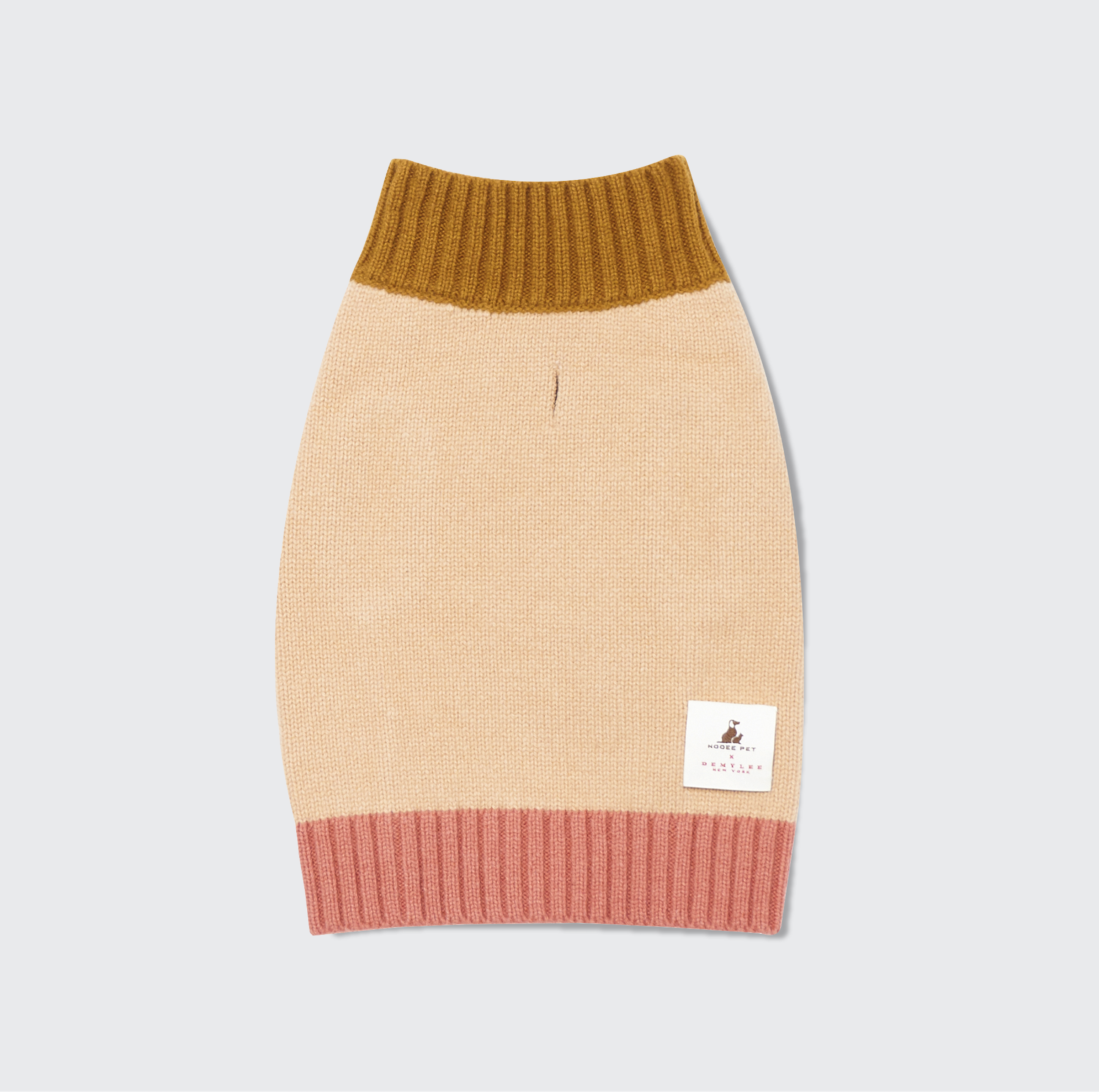 Fawn-colored merino wool dog sweater with mustard ribbed turtleneck and pink hem, featuring Nooee Pet x DEMYLEE New York label.