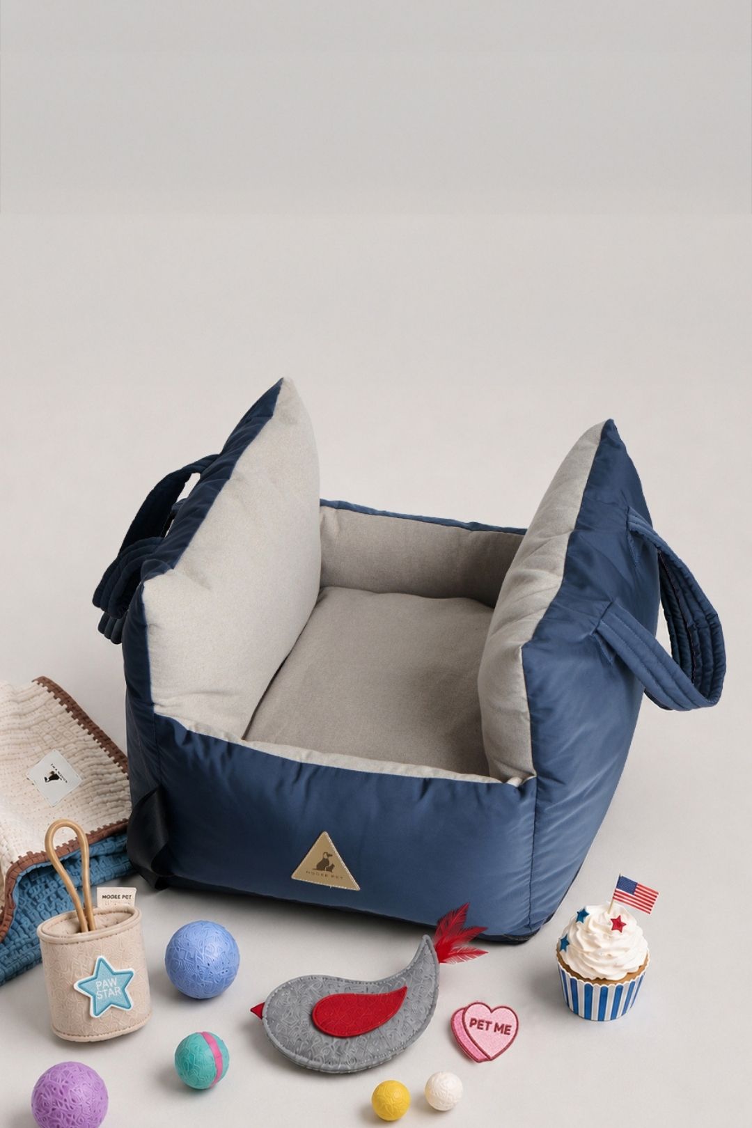 Nooee Pet Charlie navy dog car seat with blanket, toy, Paw Star patch, and Pet Me patch in a July 4th weekend sale display.