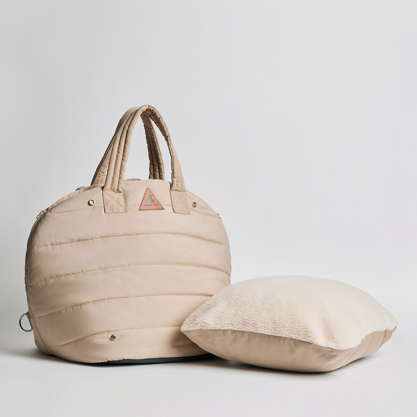 Nooee Pet Lola Car Seat in cream nylon shown next to its removable dual-sided cushion with fleece and waterproof sides.