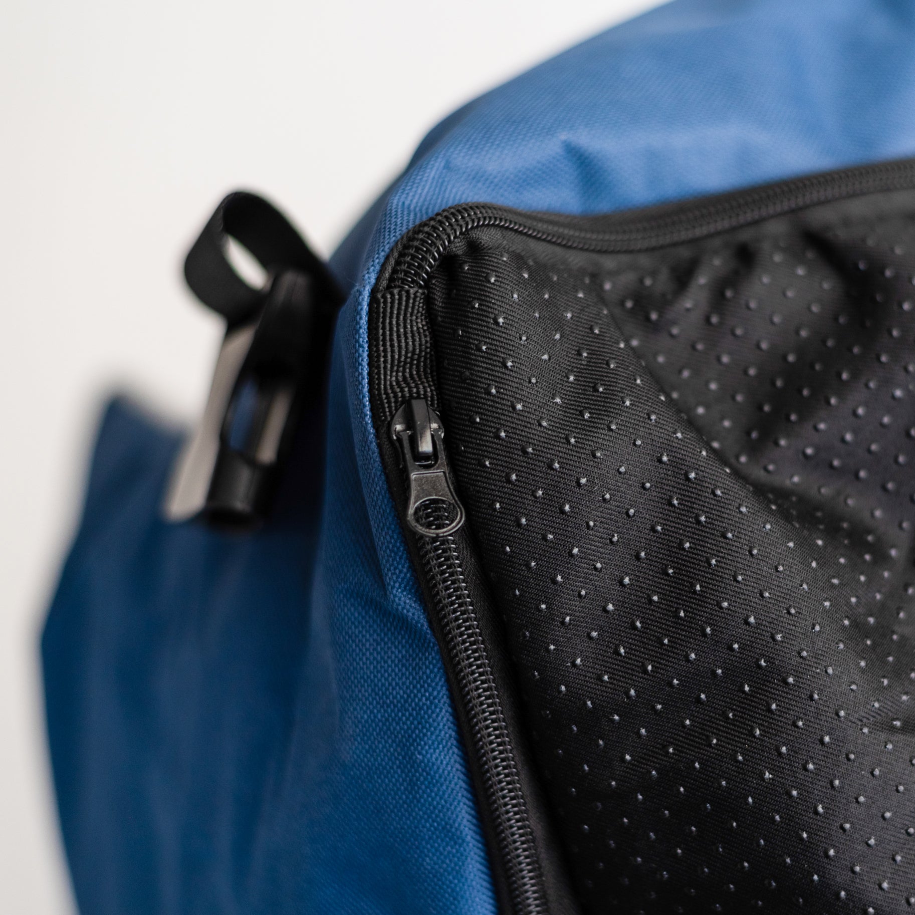 Close-up of the Nooee Pet Car Seat Charlie’s bottom panel, highlighting the textured, non-slip waterproof fabric and zippered opening for easy access to the cushion insert.