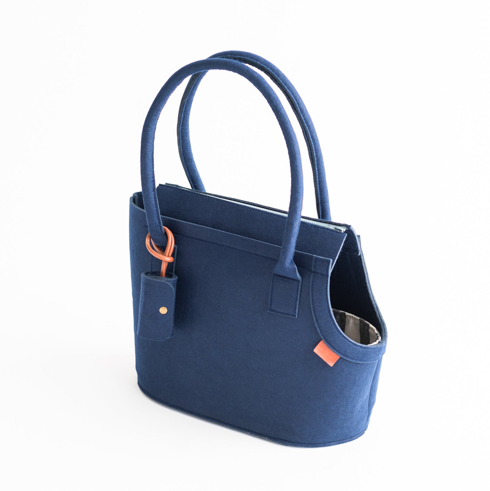 Nooee Pet Ashy Navy Dog Carrier with tall handles, side opening, and a matching navy poop bag holder attached by a leather loop.