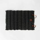 Flat-lay of Nooee Pet Jack Mat with black quilted fabric, vegan leather handles, and stitched Nooee Pet logo patch on the corner.