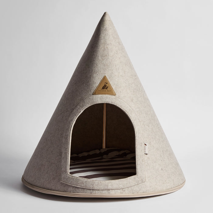 Front view of the Nooee Pet Harry Cave in cream, featuring its arched entrance, soft felt exterior, and striped cushion inside.