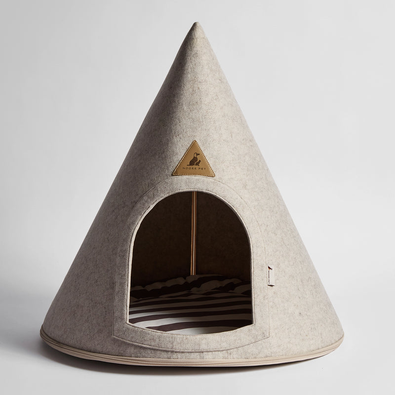 Front view of the Nooee Pet Harry Cave in cream, featuring its arched entrance, soft felt exterior, and striped cushion inside.