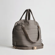 Back view of the Nooee Pet Lola Car Seat in modern gray nylon, showing adjustable bottom strap with buckle, padded top handles, and shoulder strap with silver hardware.