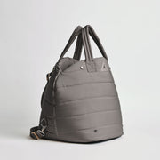 Side view of the Nooee Pet Lola Car Seat in modern gray nylon, featuring quilted padding, dual top handles, and an adjustable shoulder strap with silver hardware.