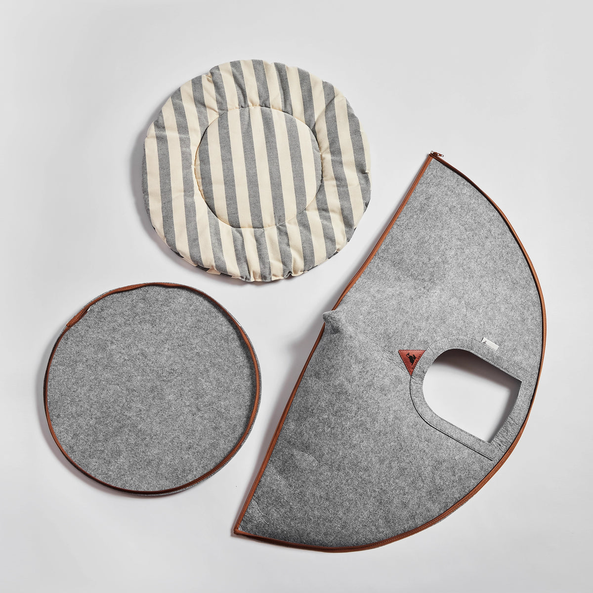 Disassembled Nooee Pet Cave Buddy (L) with its felt panels and striped cushion.