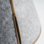 Close-up of the zipper detail on the gray Nooee Pet Toby felt dog cave