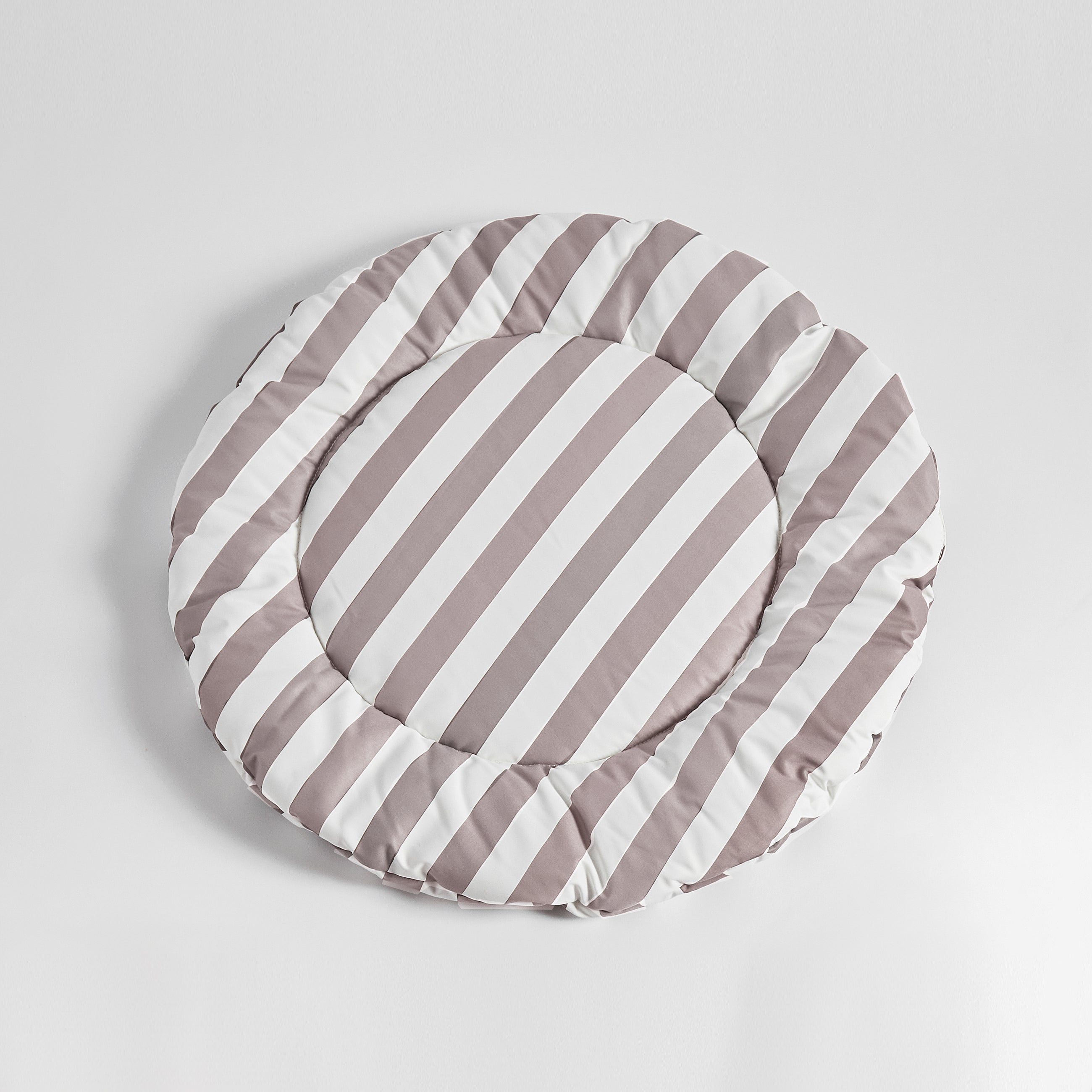 Flat-lay of Nooee Pet Replacement Cushion in beige and white stripes, showcasing its round shape and plush design against a clean white background.