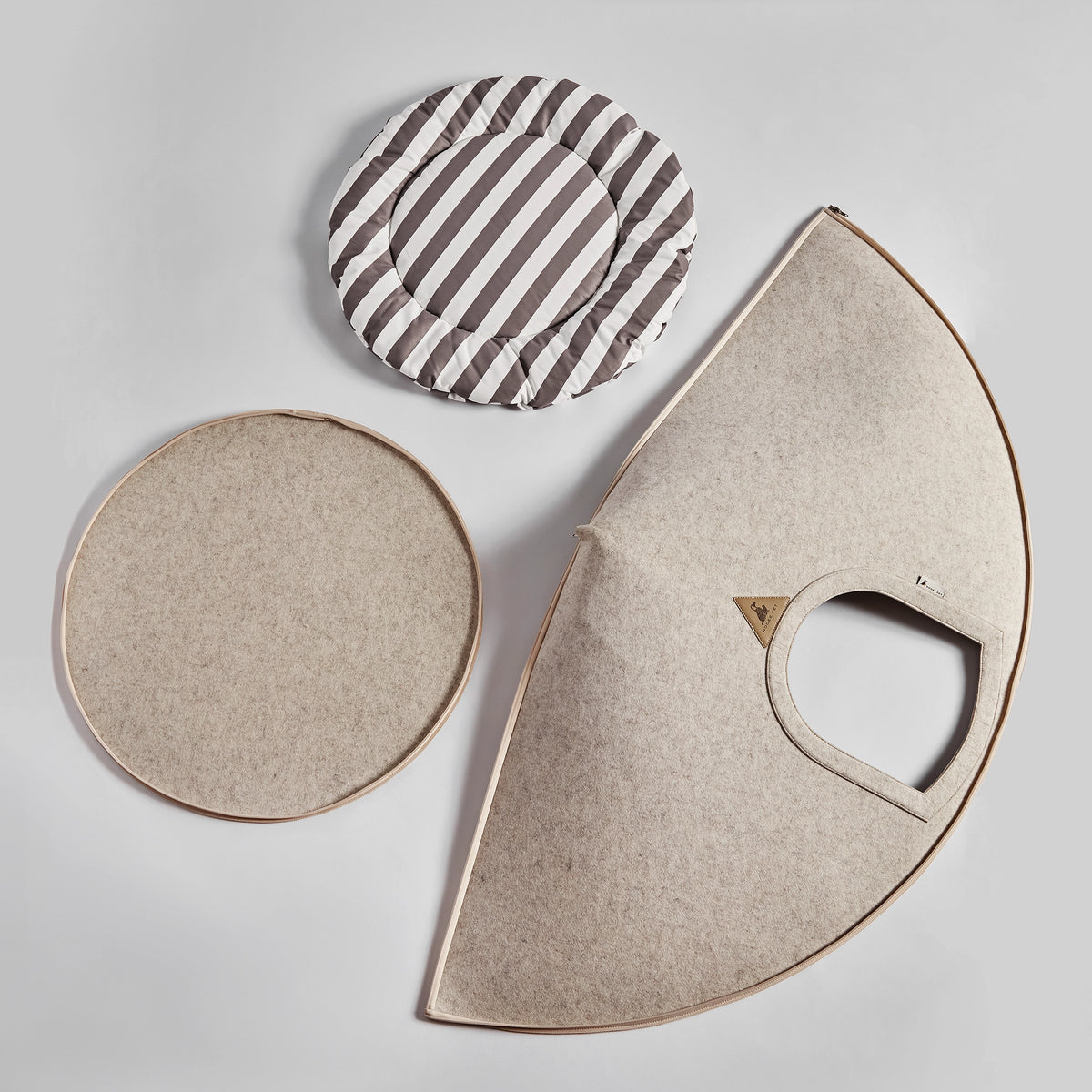 Disassembled view of the Nooee Pet Buddy Cave in Cream, featuring the foldable exterior and removable cushion.
