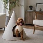 Cream Nooee Pet felt cave with a poodle sitting inside in a modern living room