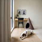 Brown Nooee Pet felt cave in a modern room with a dog resting nearby
