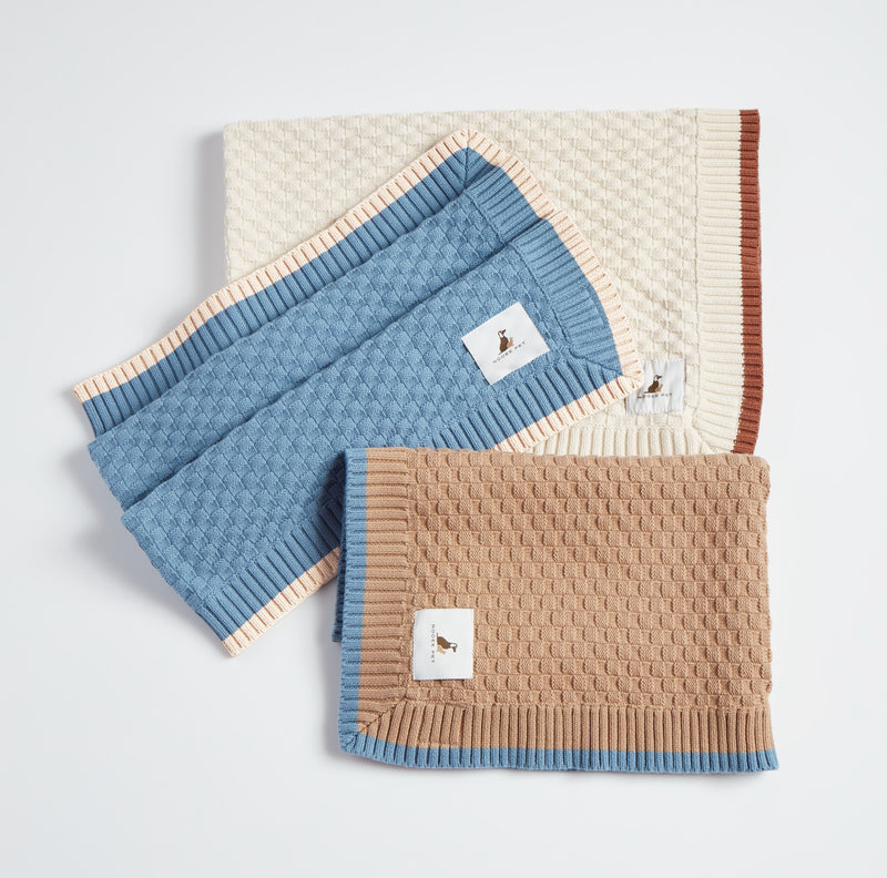Nooee Pet Cory organic cotton knit blankets in cream, blue, and beige