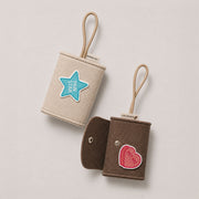 Cream and brown felt pet accessory pouches with PAW STAR and PET ME embroidered patches.