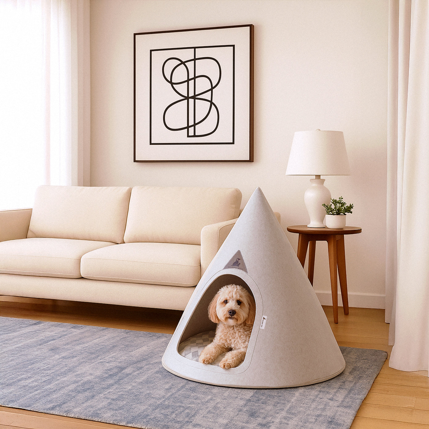 Nooee Pet Cave Molly (XL) – Cream in a modern living room with a small fluffy dog relaxing inside.