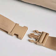 Close-up of the adjustable beige buckle strap on the Nooee Pet Lola Car Seat, designed for secure attachment to a car seat.