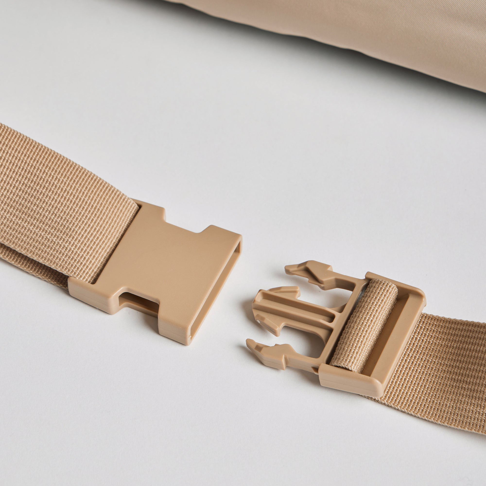 Close-up of the adjustable beige buckle strap on the Nooee Pet Lola Car Seat, designed for secure attachment to a car seat.