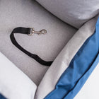 Close-up of the Nooee Pet Car Seat Charlie's inner safety tether, featuring a black strap and metal clip attached to the soft gray cushioned interior.
