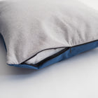 Close-up of the Nooee Pet Car Seat Charlie's removable cushion, showing the zippered opening with a two-tone design—light gray on top and navy blue on the bottom—revealing the inner insert for easy cleaning.