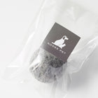 Black wool toy ball in clear packaging