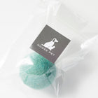Green wool toy ball in clear packaging