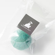 Green wool toy ball in clear packaging