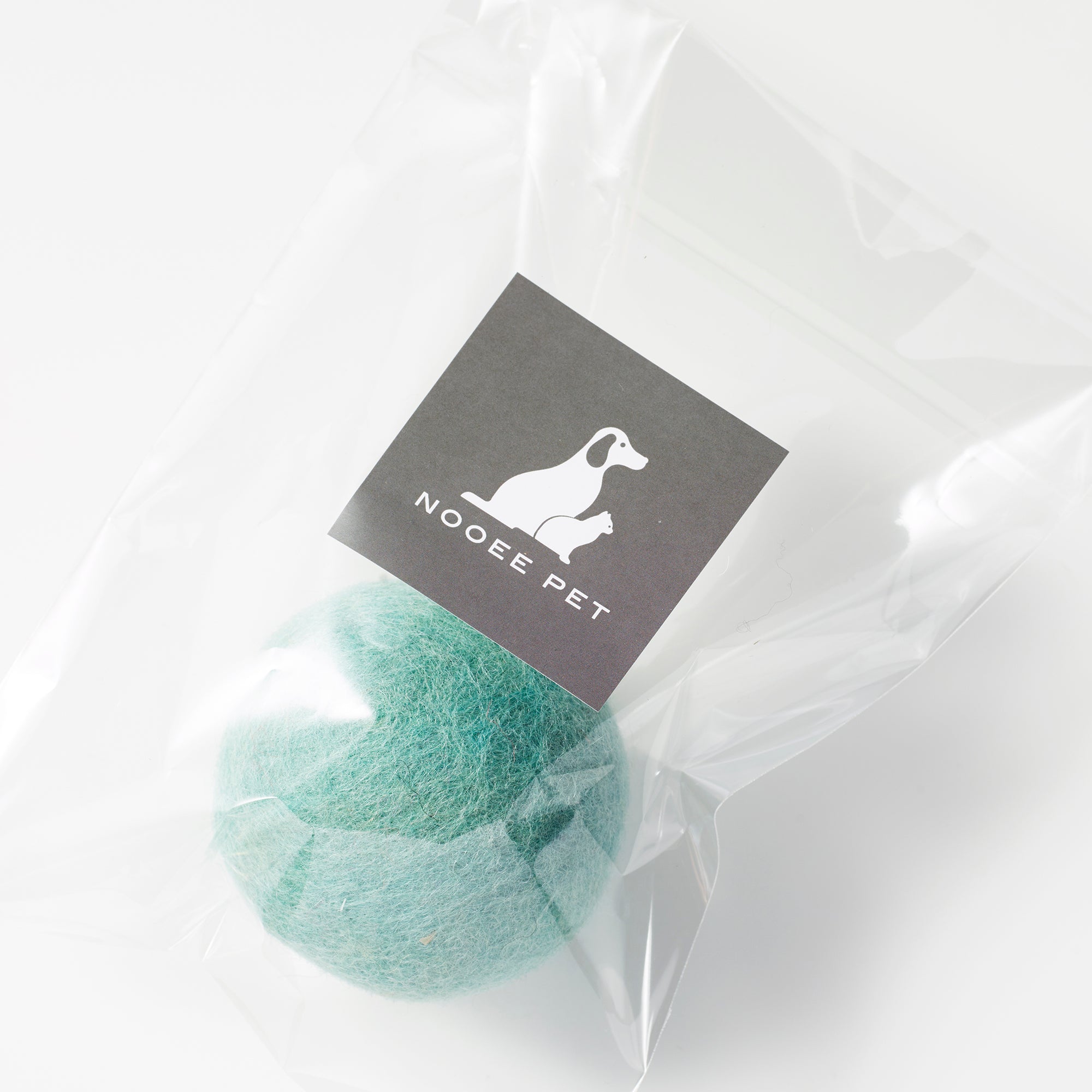Green wool toy ball in clear packaging