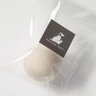 White wool toy ball in clear packaging