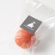 Orange wool toy ball in clear packaging