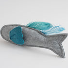 Gray felt fish-shaped toy with a blue felt fin and matching feather tail, displayed on a white background.